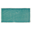 A rectangular ceramic carnival laredo blue glazed tile with matte textured turquoise glaze and irregular edges
