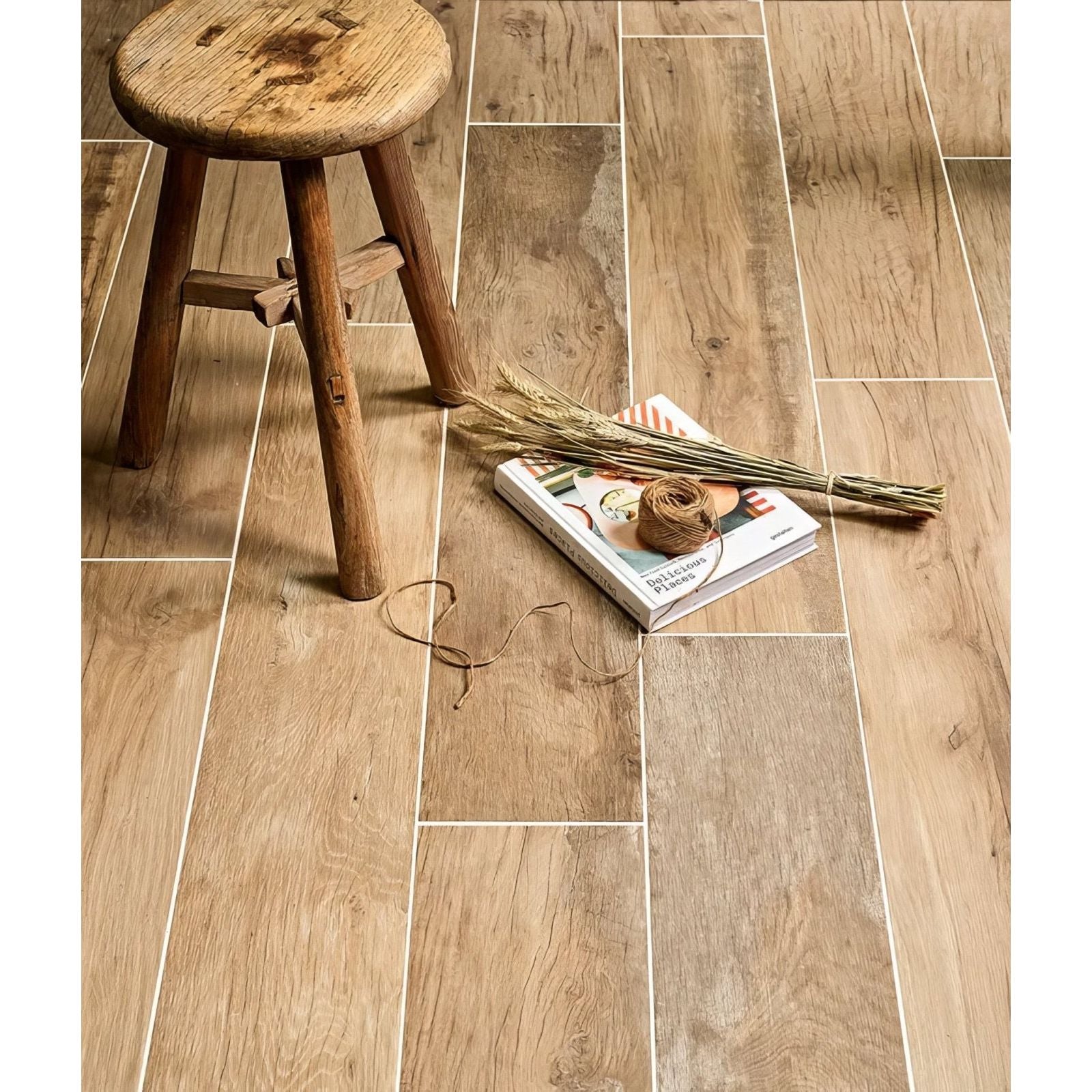 Light brown wood-grain vinyl plank flooring with a natural rustic finish in carpenter porcelain natural collection