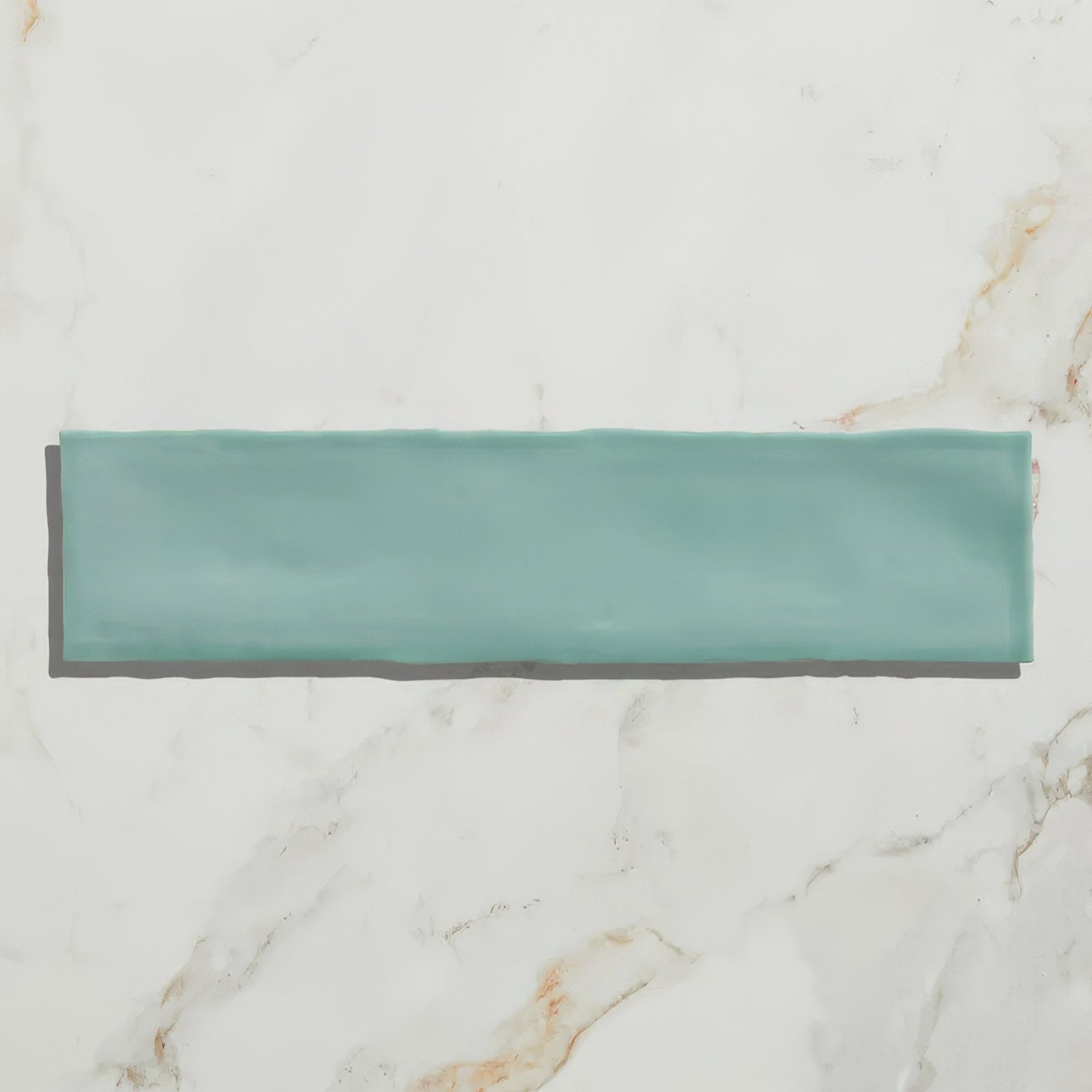 A sleek rectangular teal ceramic tile with a smooth glossy finish from carter ceramic mint collection