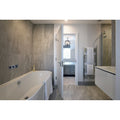 Cashmire Oyster 60 x 60cm beige marble-effect tiles with a freestanding bathtub and chrome tap