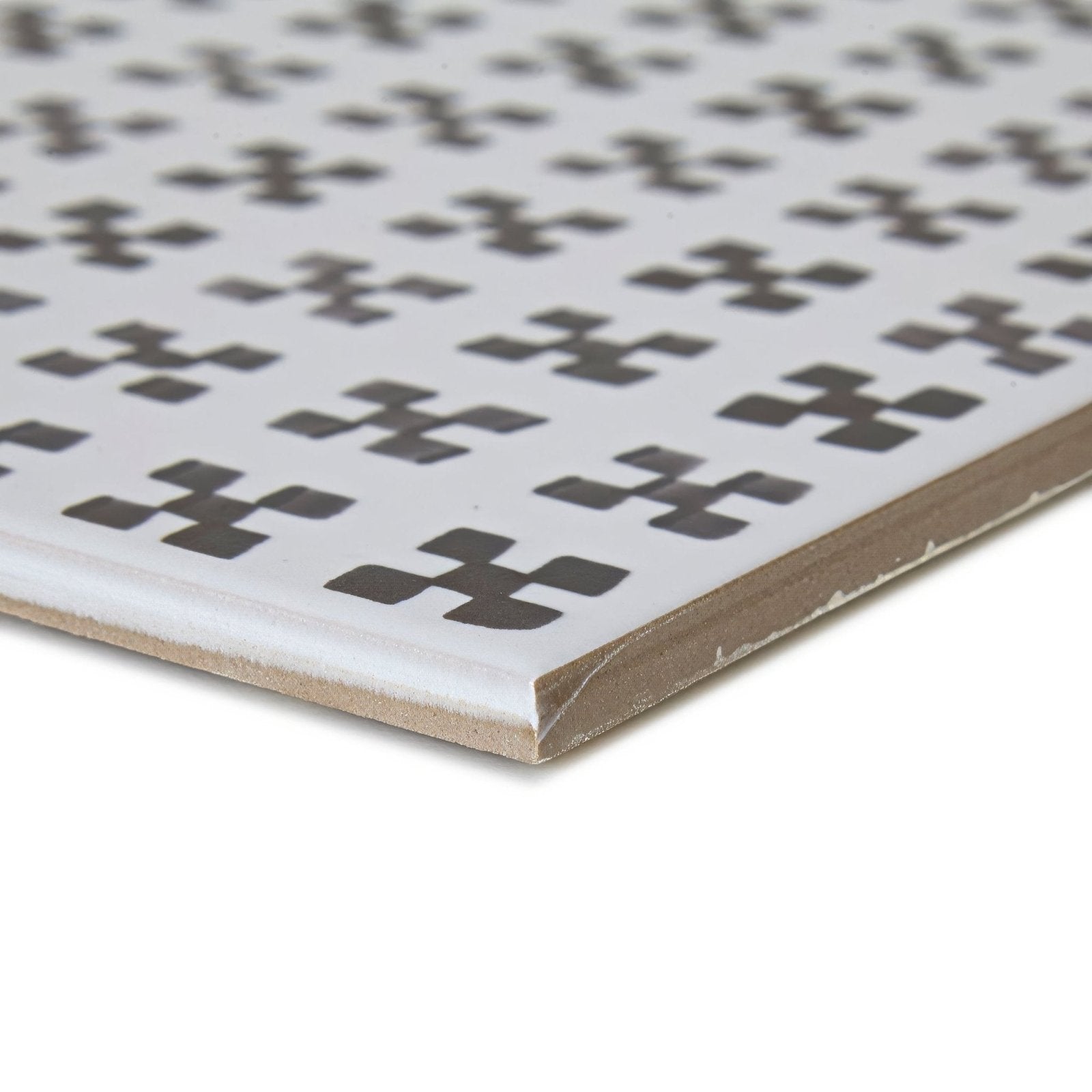 White ceramic casino baccarat patterned tile with dark gray stylized x shaped repeating motifs