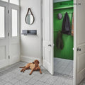 A golden brown labrador retriever lying on casino baccarat patterned tile showcasing decorative floor design