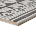 Gray and white ceramic tile with intricate geometric and curvilinear casino dealer patterned border design
