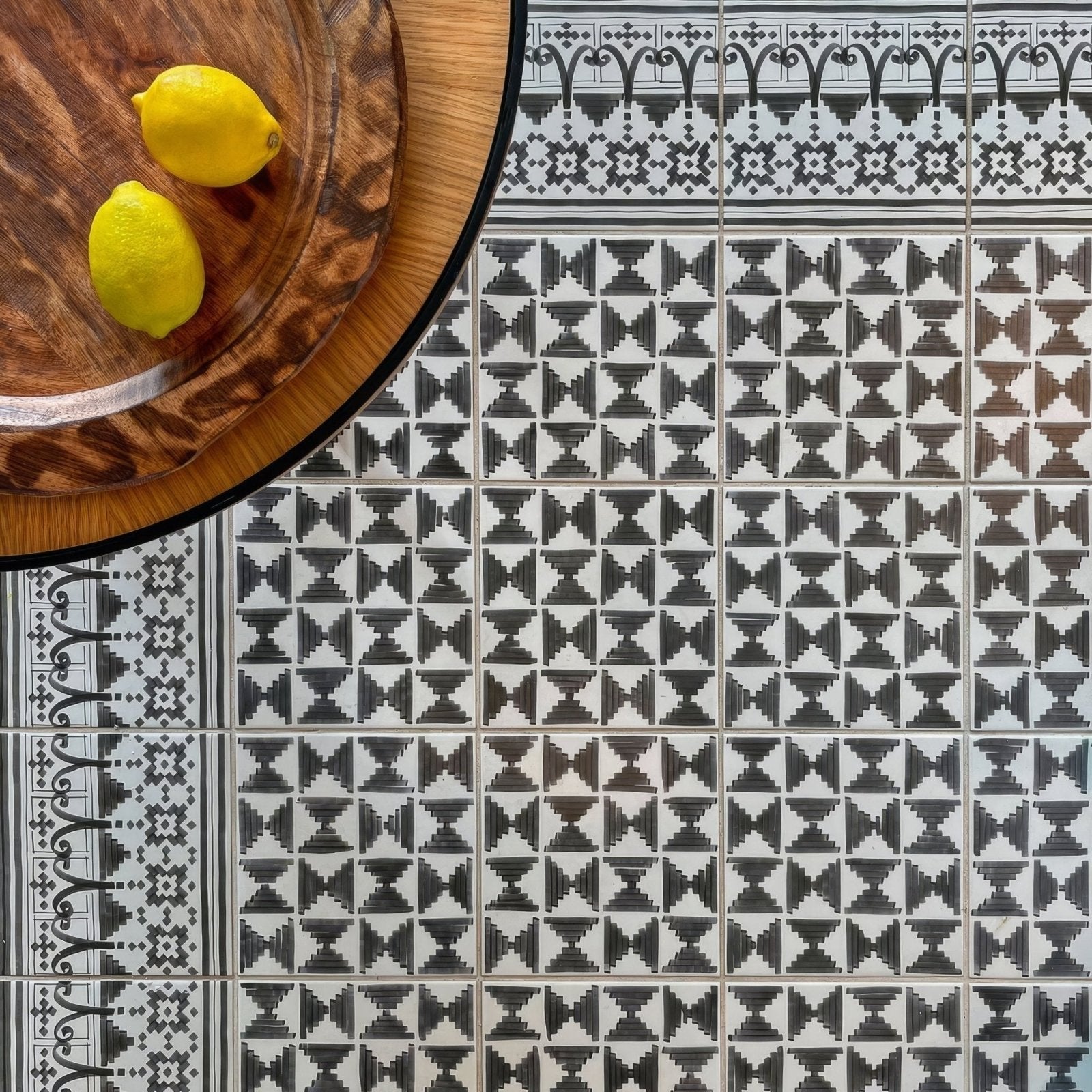 Black and white geometric patterned ceramic casino poker tile with ornate border designs for decorative use