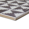 White ceramic casino poker patterned tile with dark gray geometric angular shapes and horizontal lines