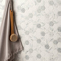 White and gray hexagonal caspar recycled glass mosaic tile wall with marble-patterned and silver geometric accents