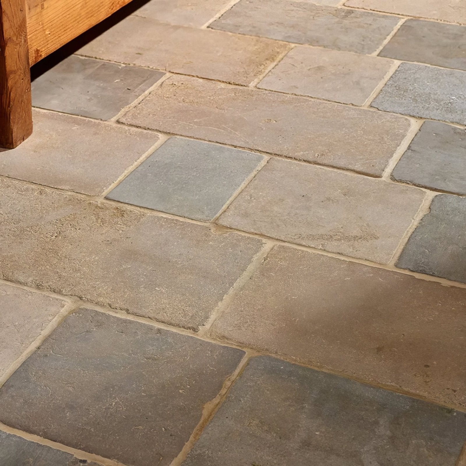 Castilan limestone cobbles tumbled natural stone flagstones in varying gray and beige shades laid in a rustic pattern