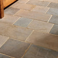 Castilan limestone cobbles tumbled natural stone flagstones in varying gray and beige shades laid in a rustic pattern
