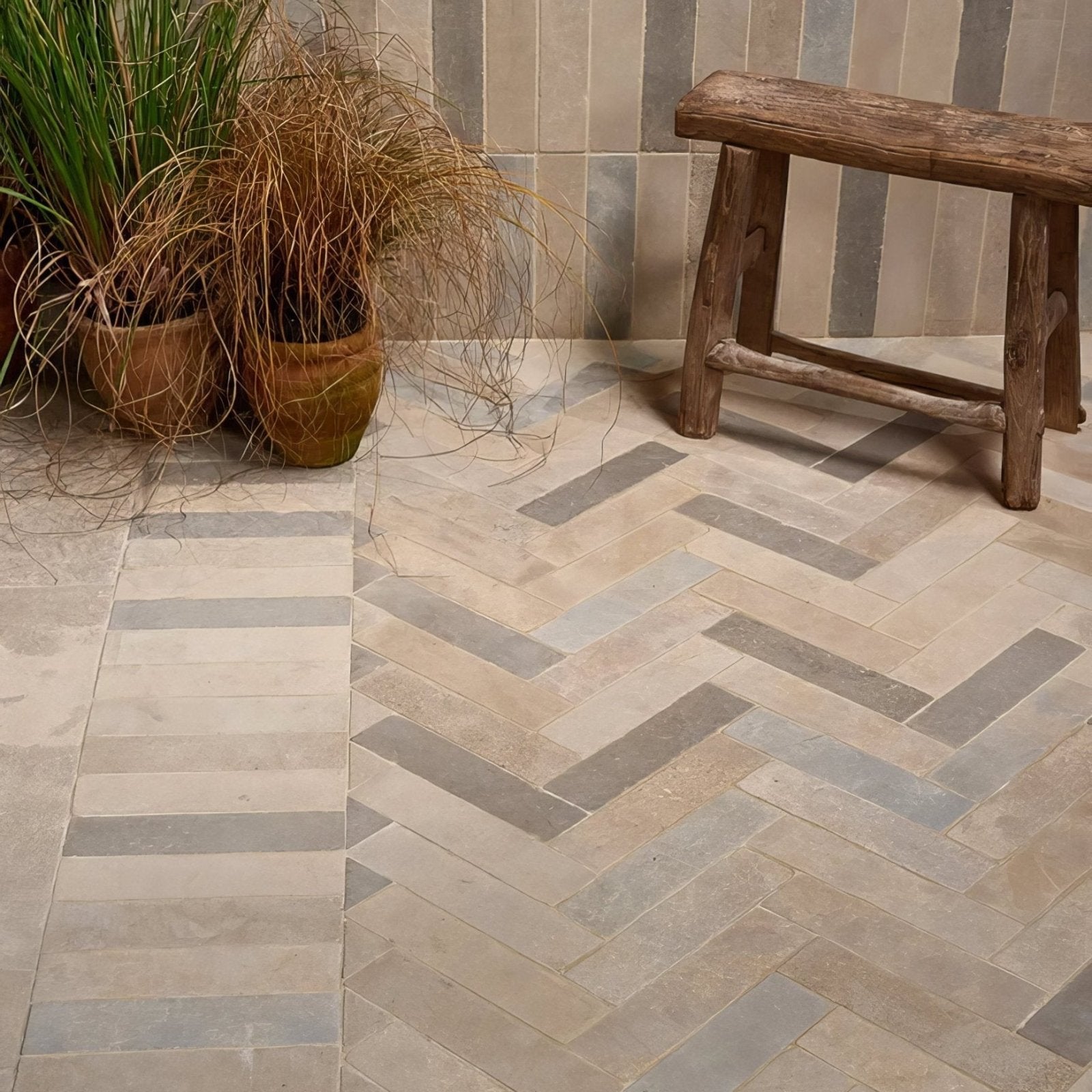 Beige and gray herringbone patterned castilan limestone parquet tumbled stone floor tiles