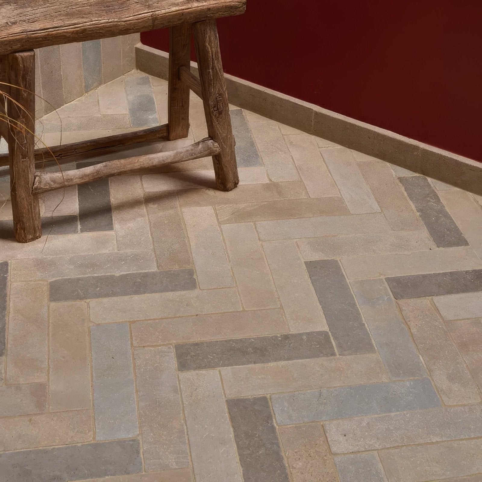 Beige and gray herringbone patterned castilan limestone parquet tumbled stone floor tiles