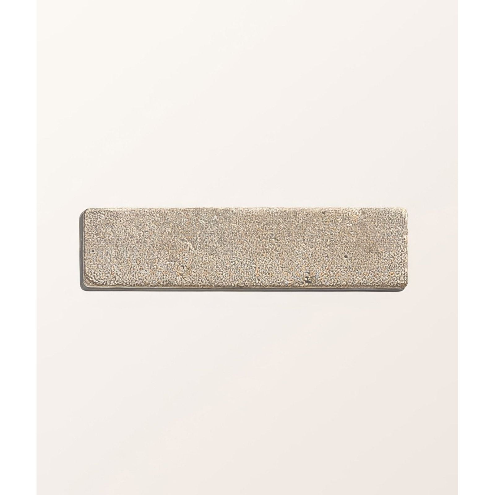 A rectangular silver-toned castilan limestone tumbled klinker with a matte finish and subtle surface texture