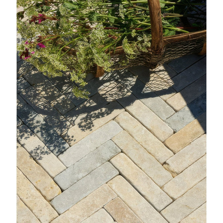Castilan limestone tumbled klinkers stone pavers in herringbone pattern with natural beige and gray tones
