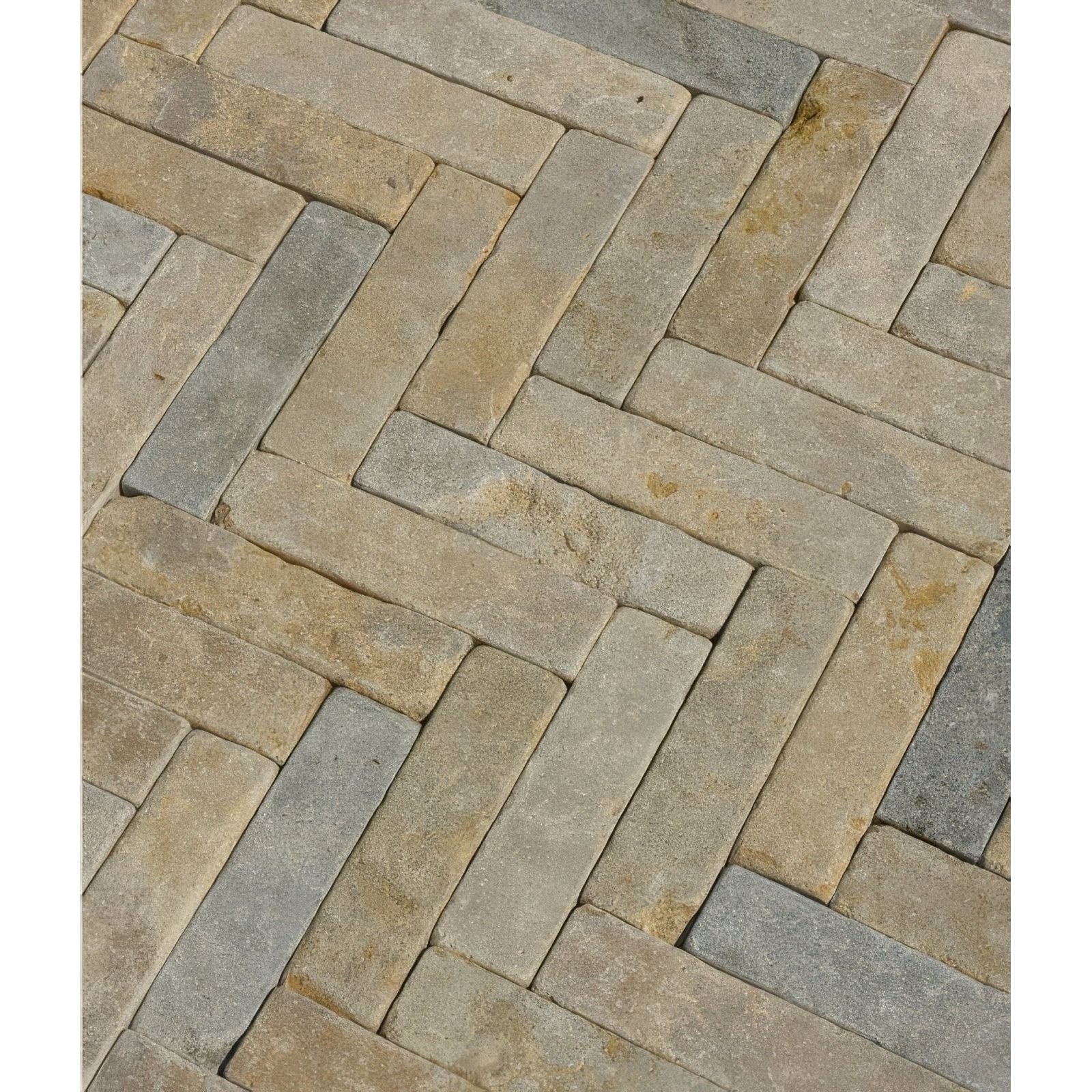 Castilan limestone tumbled klinkers featuring herringbone-patterned stone pavers in natural beige and gray tones