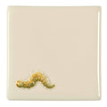 Cream-colored ceramic coaster with a detailed hand-painted yellow and green caterpillar in the caterpillar on off white design