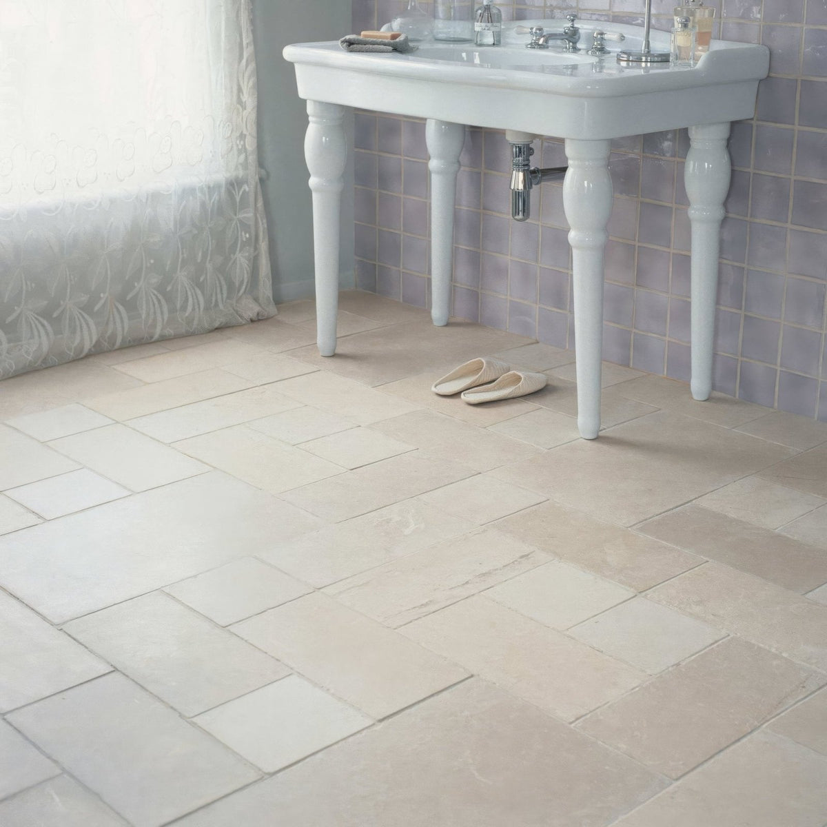 Beige herringbone patterned ceramic bathroom floor tiles cathedral classic 20 x 40cm installed in a bathroom setting