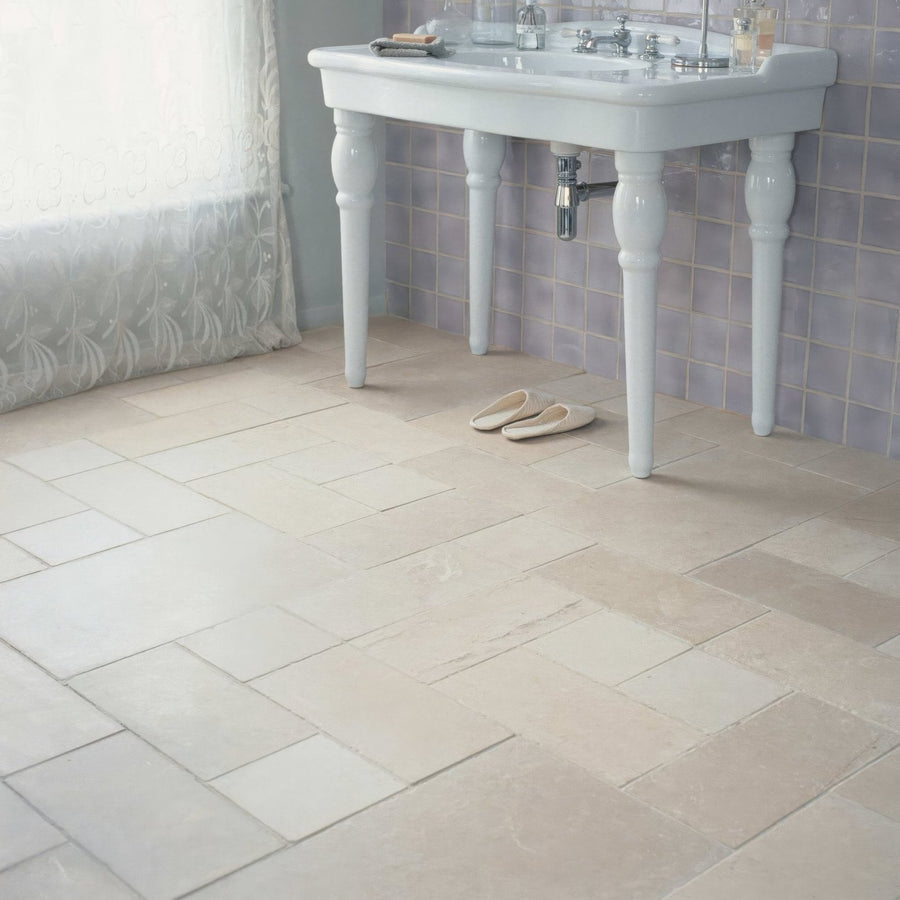 Beige herringbone patterned ceramic bathroom floor tiles cathedral classic 20 x 40cm installed in a bathroom setting