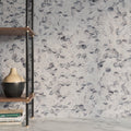 Close detail of polished Calacatta Viola marble hexagons showing aubergine and oxblood veining on ivory