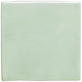 A square translucent mint-green glass tile with subtle wavy embossed patterns celadon field tile