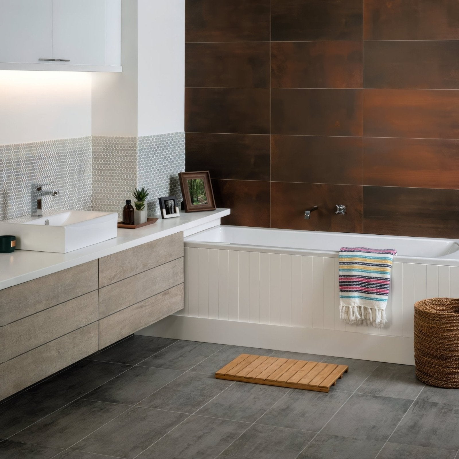White rectangular vessel sink with sleek chrome faucet on light wood vanity in celaya grey matt glazed porcelain finish