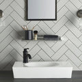 White rectangular basin with a matt black tap against a wall tiled in Chancel Grey Large Brick