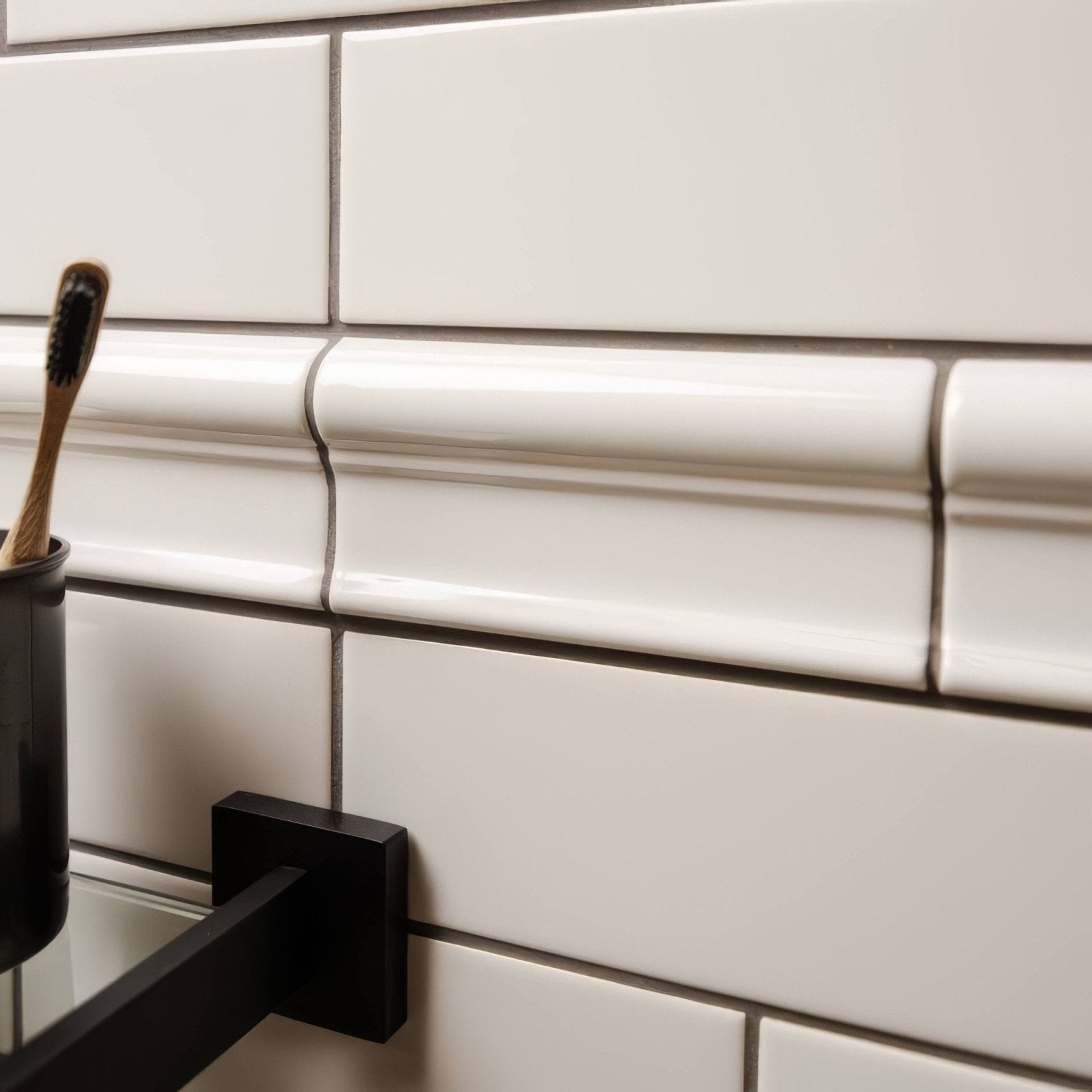 White subway tile with glossy finish and subtle gray grout lines featured in chancel grey victoria moulding