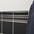 Charcoal Grey Omega Moulding running as a bead course in gloss ceramic above field tiling with white grout