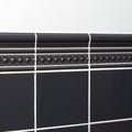 Charcoal Grey Scroll Moulding detail in gloss ceramic, its wave profile catching the light above charcoal field tiles