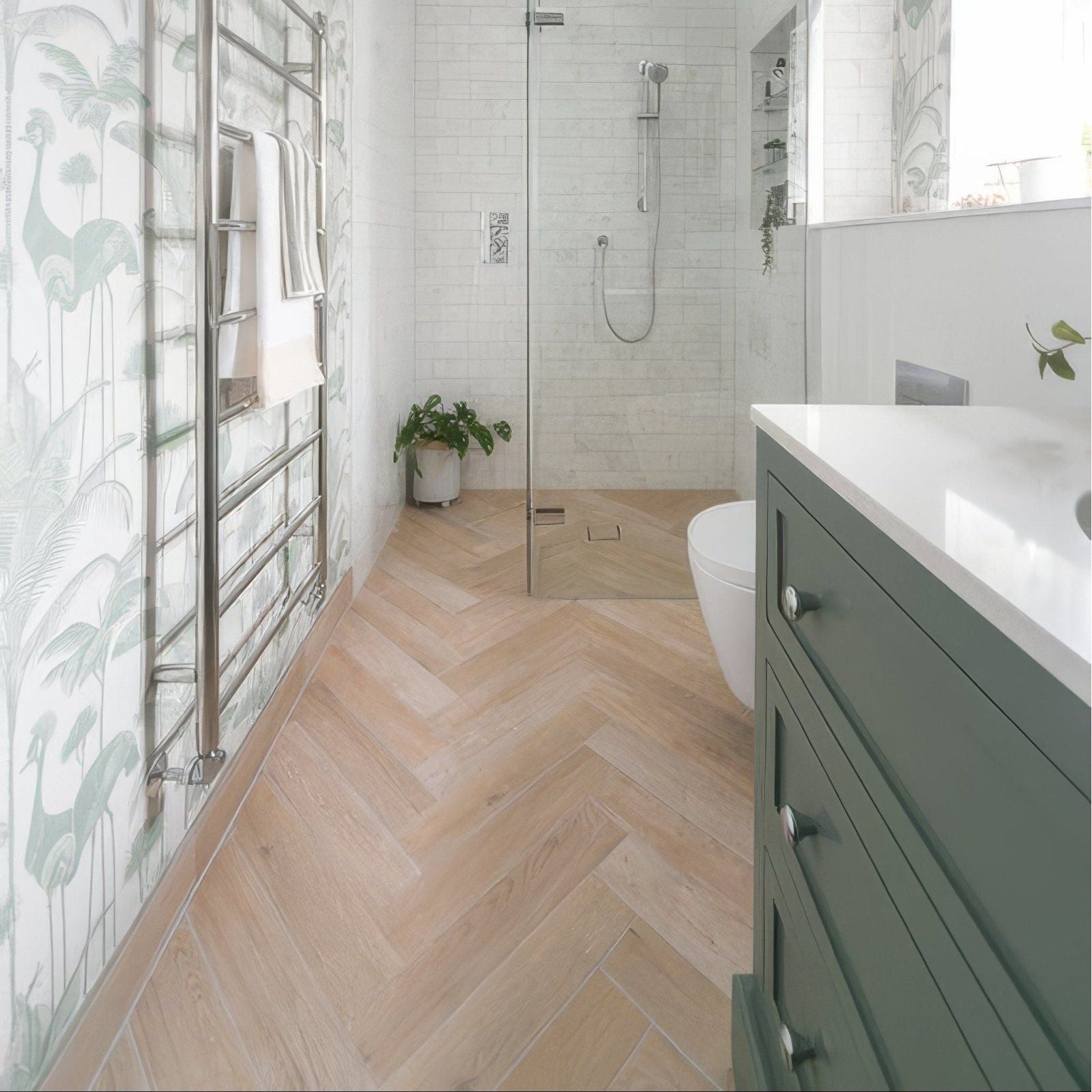 Light wood herringbone patterned porcelain oak floor tiles designed for bathroom use in the chatham collection