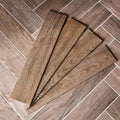 Brown wood-grain vinyl floor tiles in chatham porcelain walnut arranged in a herringbone pattern