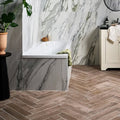 White porcelain bathtub chatham walnut with vertical ribbed texture and green towel draped over the edge