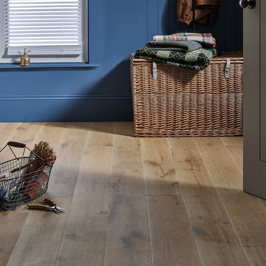 Light brown wood effect laminate flooring with natural grain pattern in chepstow silverglade oak design