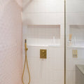 Gold-toned chic ceramic white showerhead with sleek modern design and flexible hose for enhanced bathroom style