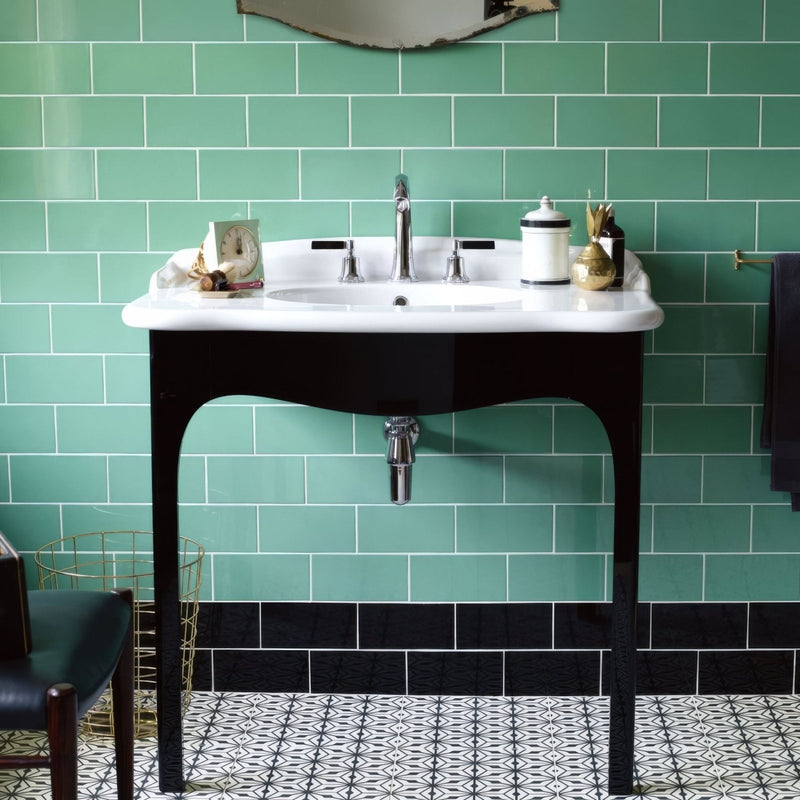 White ceramic sink with black legs and chrome faucet paired with cinema lincoln rectangle glazed tile background