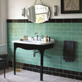 Black vintage-style bathroom sink with white ceramic basin and curved legs shown with Cinema Lincoln rectangle glazed tile