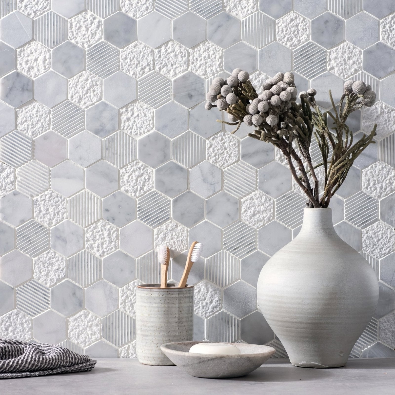A matte white ceramic cirrus large stone hexagon vase with a rounded body and subtle horizontal ridges