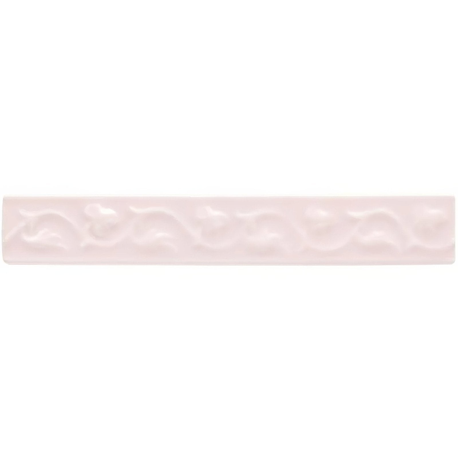 A delicate pale pink ceramic tile clare beaulieu with a subtle embossed wave pattern for decorative use