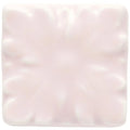 A soft pink ceramic tile clare knightsbridge with a subtle raised floral pattern for decorative use