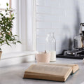 Cloud smooth brick tile with a marble countertop surface featuring an open aged book with yellowed pages