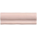 A sleek matte-finished pink ceramic clover torus moulding tile with subtle wavy texture and rounded edges