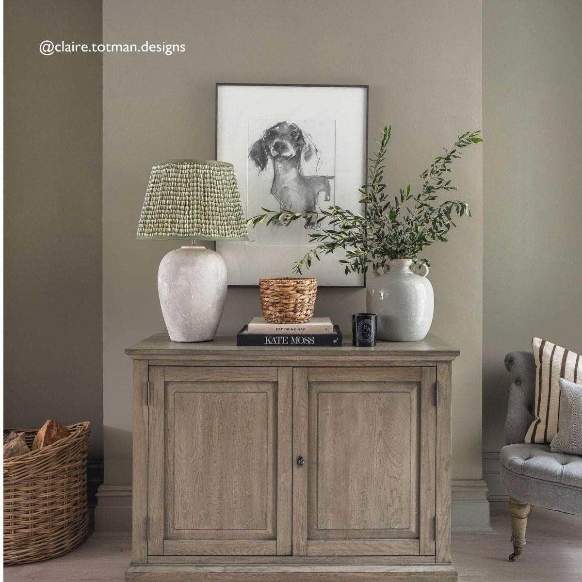 Light gray ceramic table lamp with a woven green shade from the cobble collection