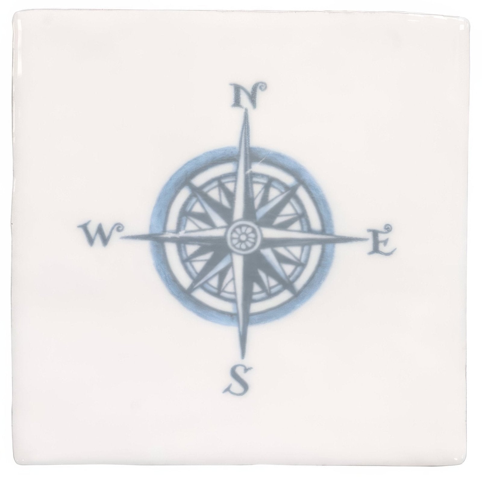 White ceramic coaster with a blue and gray compass rose design featuring cardinal directions in compass blue on cotton design