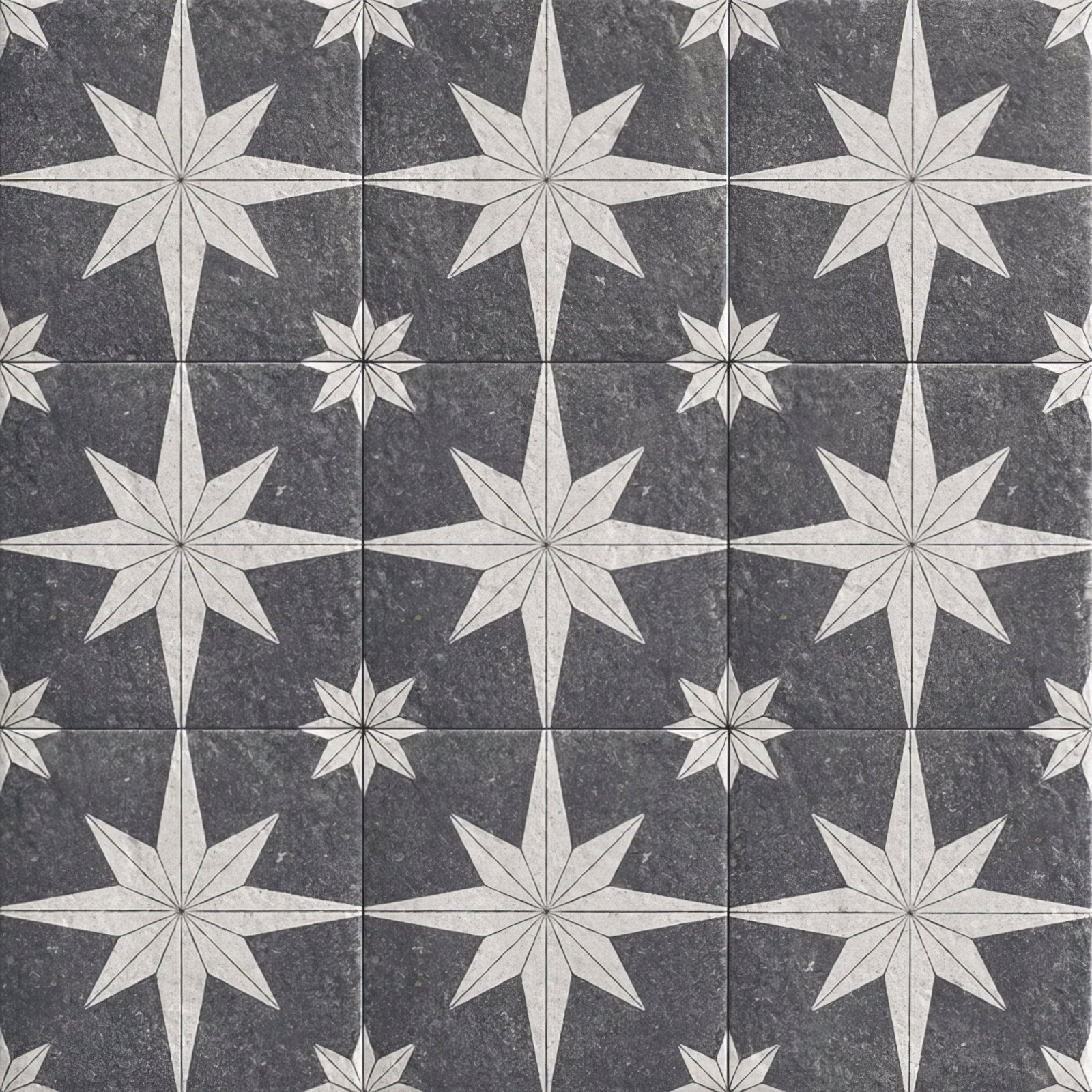 Dark gray stone tiles with intricate white starburst patterns in a repeating mosaic design compass lava black