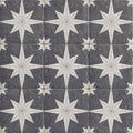 Dark gray stone tiles with intricate white starburst patterns in a repeating mosaic design compass lava black