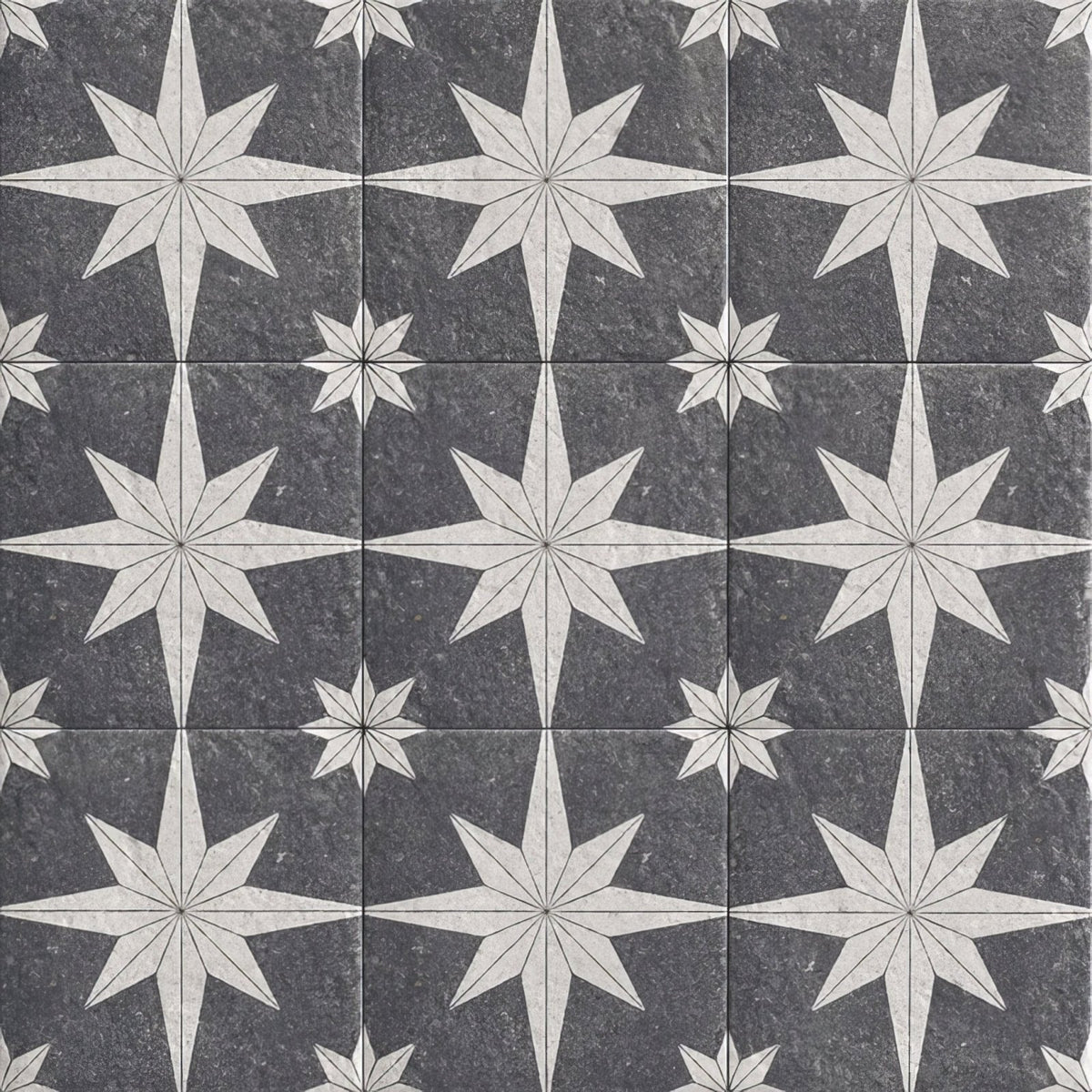 Dark gray stone tiles with intricate white starburst patterns in a repeating mosaic design compass lava black