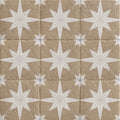 Beige stone tiles with white starburst inlay patterns from compass sand beige collection for interior flooring