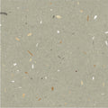Confetti green terrazzo effect tile with gray base and scattered white beige and dark brown specks for flooring and walls