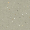 Confetti green terrazzo effect tile in gray with a speckled pattern of white beige and dark fragments