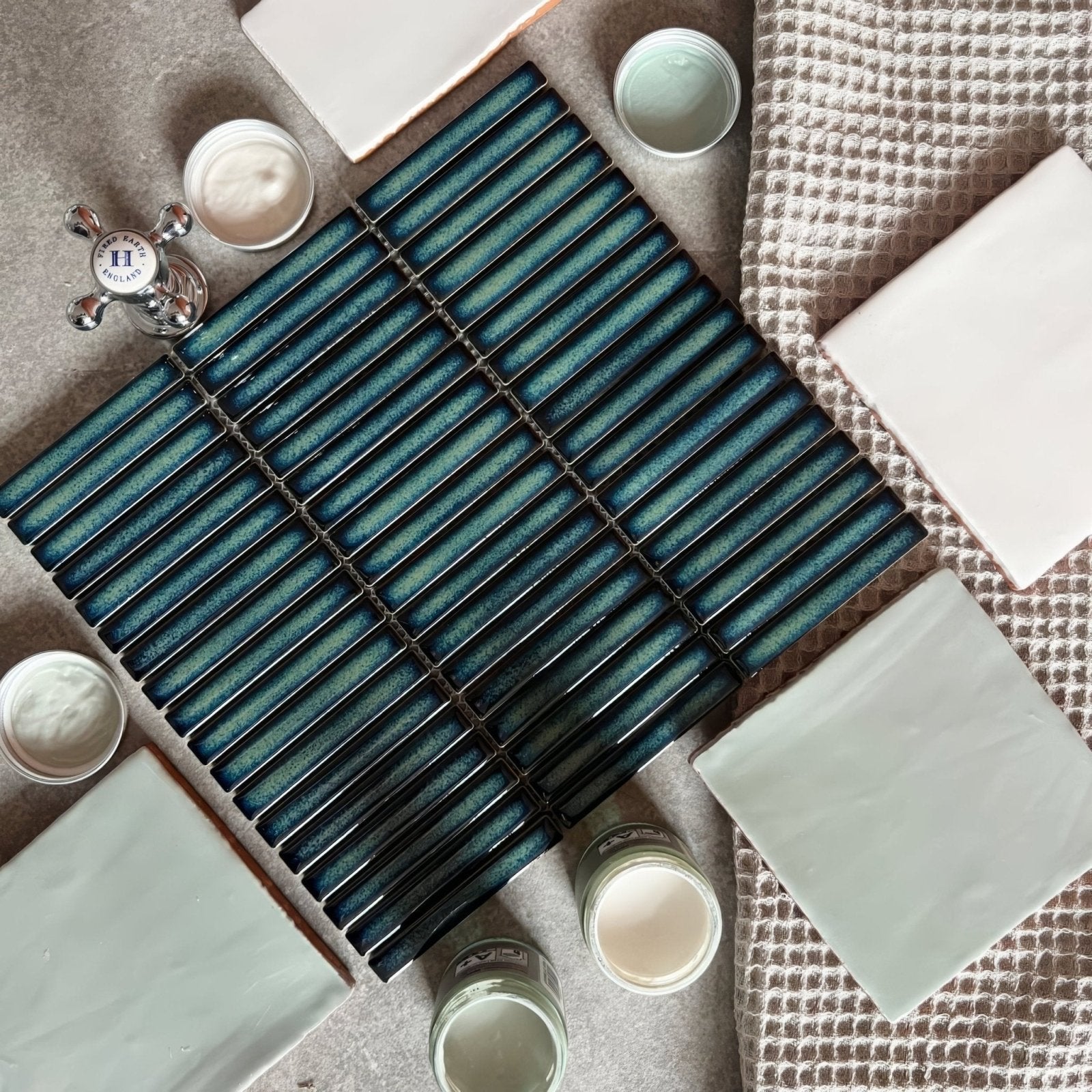 Teal ceramic subway tile with glossy gradient finish and black grout lines from copenhagen kit kat dark green mosaic