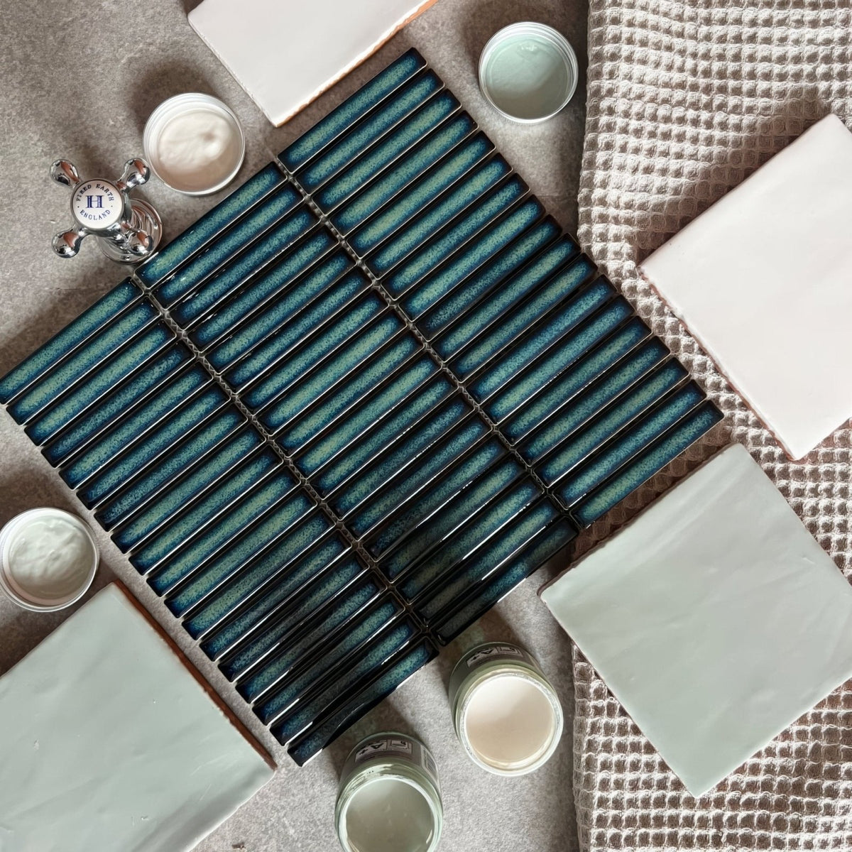 Teal ceramic subway tile with glossy gradient finish and black grout lines from copenhagen kit kat dark green mosaic