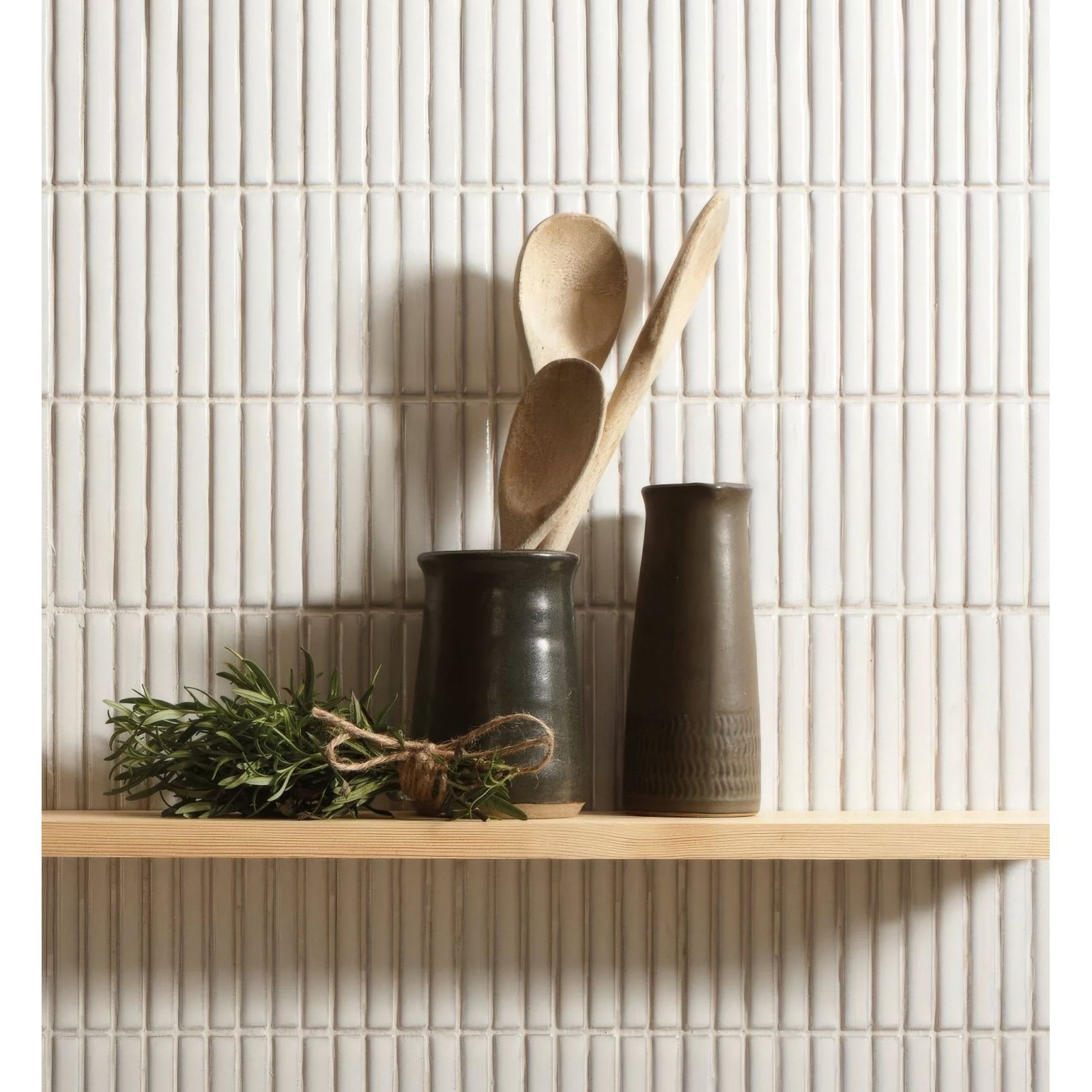 Dark ceramic utensil holder with matte finish holding wooden spoons and fresh herbs for copenhagen kit kat white mosaic